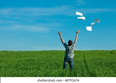 Young Man Throwing A Paper In The Green Field