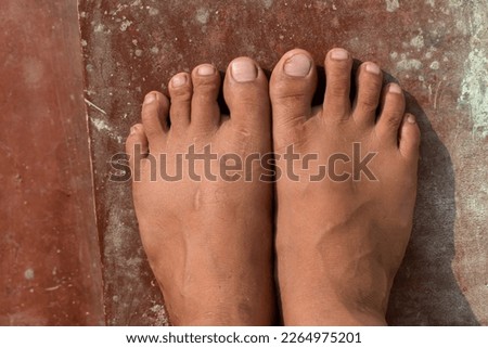 Young man toe closeup on a floor.