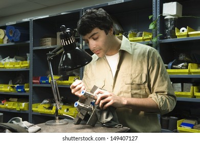 Young man with tools working in workshop