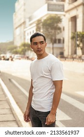 Young Man With Top Knot Standing In The City Under The Sunset