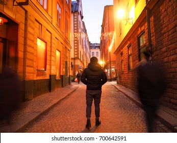 Young Man Tourist Walking On Gamla Stan Is The Old Town Of Stockholm, Sweden At 7 Feb 2016, Night View Street.