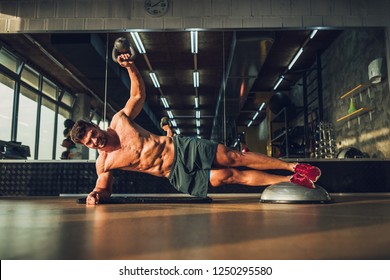 Young man training at the gym with fitness equipment