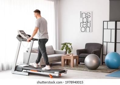 Young Man Training On Treadmill At Home