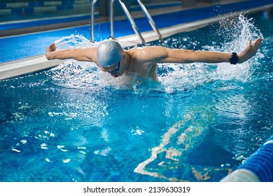 Young Man Training In Pool In Evening Time