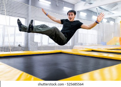 A young man trampolining in fly park - Shutterstock ID 525685564