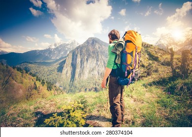 Young Man Traveler With Backpack Relaxing Outdoor With Rocky Mountains On Background Summer Vacations And Lifestyle Hiking Concept