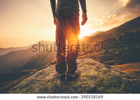 Young Man Traveler feet standing alone with sunset mountains on background Lifestyle Travel concept outdoor 