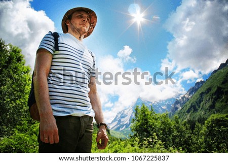 Similar – young man with hat in front of mountain panorama