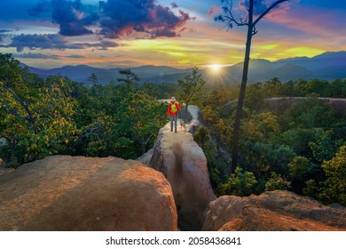 Young man trekking along Pai canyon in Mae hong son province, Thailand. Adventure, trekking and trail concept.
