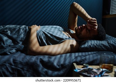 Young Man In Trouble Staying Up All Night Unable To Get Asleep While Remembering Traumatic Event Which Caused PTSD