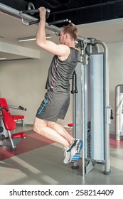 Young man is trying to do chin-ups - Shutterstock ID 258214409