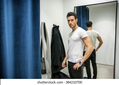 Young Man Trying On Clothes In Clothing Store