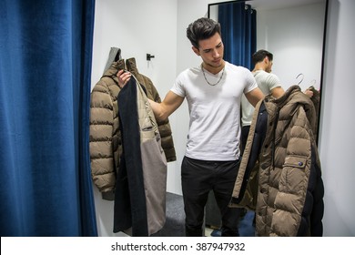 Young Man Trying On Clothes In Clothing Store