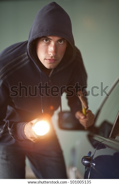 Young man trying to steal a\
car