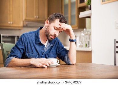 Young Man Trying To Wake Up With A Cup Of Black Coffee At Home