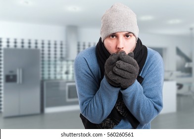 Young Man Trying To Warm His Hands And Feeling Cold In The House With Text Area