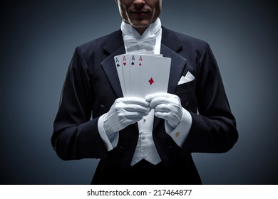Young man in a tuxedo with cards