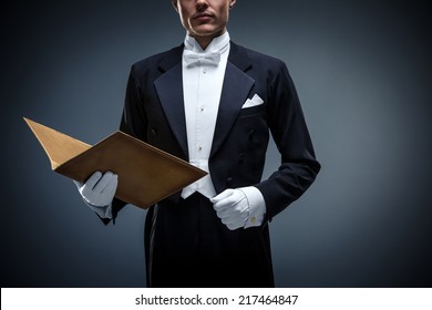 Young man in a tuxedo with folder