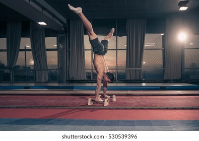 Young Man, Two Hand Cartwheel. Sunset, Dark Indoors Hall, Windows.