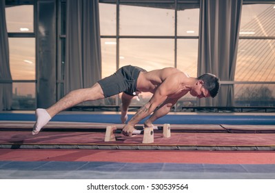 Young Man, Two Hand Cartwheel. Sunset, Indoors Hall, Windows.