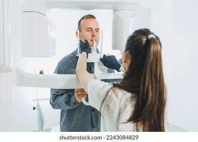 A young man underwent a CT scan of the jaw, a circular image of the jaw in modern dentistry. Radiology, panoramic scanner.