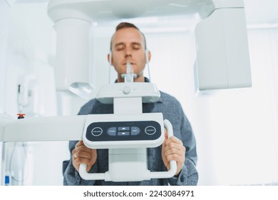 A young man underwent a CT scan of the jaw, a circular image of the jaw in modern dentistry. Radiology, panoramic scanner.
