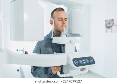 A young man underwent a CT scan of the jaw, a circular image of the jaw in modern dentistry. Radiology, panoramic scanner.