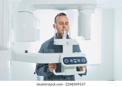 A young man underwent a CT scan of the jaw, a circular image of the jaw in modern dentistry. Radiology, panoramic scanner.