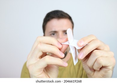 Young Man Unwrapping Medical Bandage Plaster 