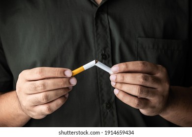 The Young Man Used His Hand To Break A Cigarette Into Two. He Wants To Quit Smoking For Good Health. World Tobacco Day.