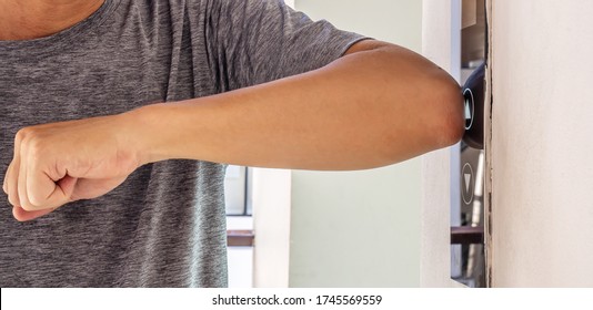 The Young Man Uses An Elbow To Press The Elevator Button To Prevent The Spread Of The Covid19 Or Coronavirus