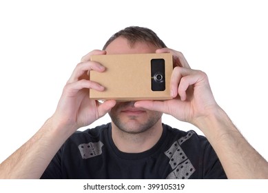 Young Man Uses Virtual Reality (VR Cardboard) Isolated On White Background