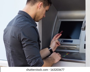 Young Man Using ATM 