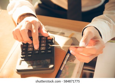 Young man using calculator with credit card for shopping internet online ,selective focus.