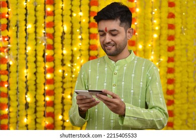 Young Man Using Credit Card And Mobile For Shopping,wearing Kurta On Festival