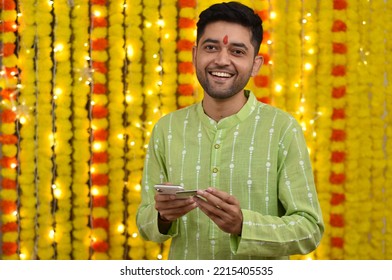 Young Man Using Credit Card And Mobile For Shopping,wearing Kurta On Festival