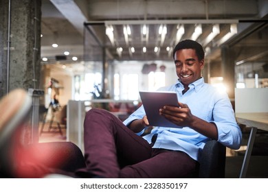 Young man using a digital tablet while working in a startup company office