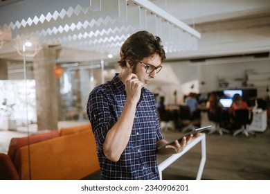 Young man using a digital tablet while working in a startup company office