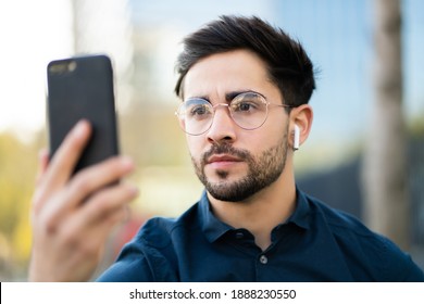 Young Man Using Face Id For Unlock Mobile Phone Outdoors.