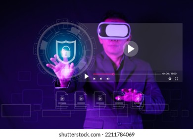 Young Man Using Glasses Of Virtual Reality On Dark Background. Smartphone Using With VR Headset,virtual Reality,future Technology Concept.VDO Simulation ,cyber Security ,network Security