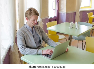 Young man using lap top in the cafe