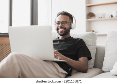 Young Man Using Laptop Computer At Home, Relaxed Man Working From Home. Freelance Work, Student Lifestyle, Distance Education, Web Conference, Online Learning, Study, Meeting, Leisure Concepts