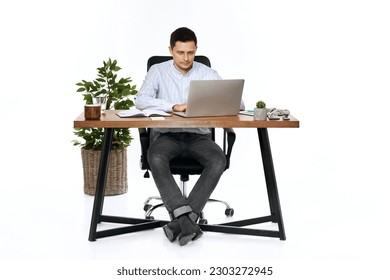 young man using laptop computer for online work at table
