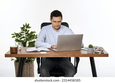 young man using laptop computer for online work at table
