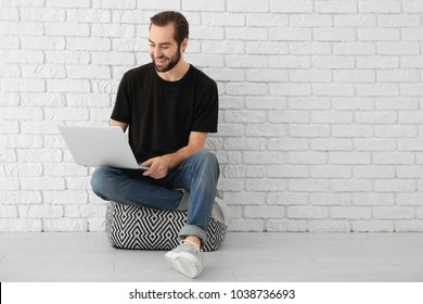 Young Man Using Laptop Indoors