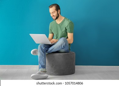 Young Man Using Laptop Indoors