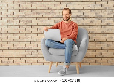 Young man using laptop indoors - Shutterstock ID 1057014818