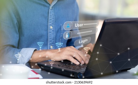 Young man using laptop and login with wifi internet at cafe or home and work - Shutterstock ID 2130639692