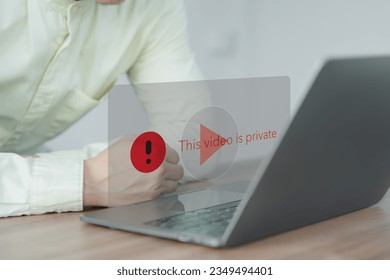 Young man using a laptop to play social media but this video is blocked or privacy settings have been set. Searching for more internet, and search engine optimization. Subscribing and following.