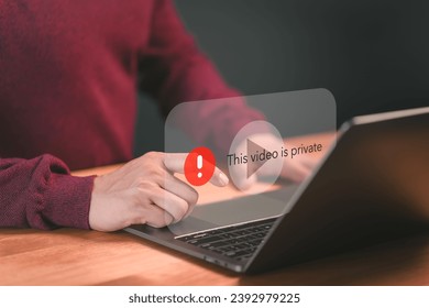 Young man using a laptop to play social media but this video is blocked or privacy settings have been set. Searching for more internet, and search engine optimization. Subscribing and following.